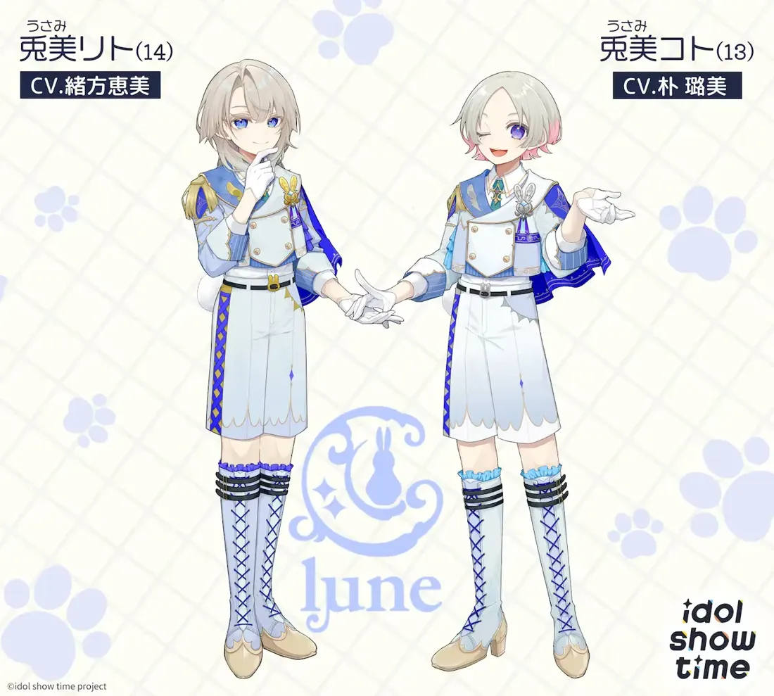 Promotional artwork for the Idol Show Time project, featuring two anime-style male characters,  Usumi Rito and Usumi Koto.  Rito, on the left, has shoulder-length light grey hair and is wearing a light blue and white officer-style uniform with gold accents, including knee-high laced boots. He is holding his hands together delicately.  Koto, on the right, has shorter grey hair with pink highlights and a similar light blue and white uniform;  he also wears knee-high laced boots, but is shown with a slightly more playful, open hand gesture. Both characters have pale skin and are presented in a light, pastel colour palette. The background features a pale grid pattern with stylized paw prints.  A stylized logo featuring a rabbit and crescent moon with the word 'lune' is in the center. Text in Japanese provides character names, ages (14 and 13), and voice actors. The overall style is reminiscent of anime character design, clean and appealing to a younger audience.